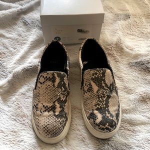 Slide on sneaker style shoes. Gray snake print